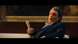 elderly man in suit giving presentation — John Wick: Chapter 4