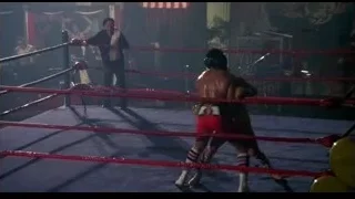 two wrestlers fighting in ring with spectators — Rocky III
