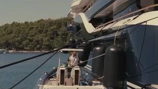 Luxury yacht docked in harbor with mountains — Succession