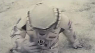 Distressed person lying on sandy ground — Interstellar