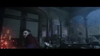 Man holding glowing wand in dark room — Doctor Strange 2