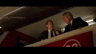 Man in suit leaning on balcony — Ford v Ferrari