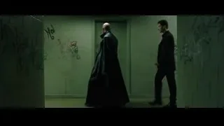 two men conversing in graffiti hallway — The Matrix