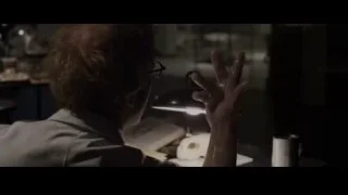 man working at desk in dark room — The Amazing Spider Man