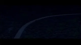 Red car driving on winding forest road at night — Cars