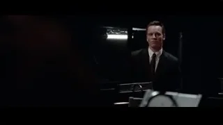 man standing at desk in dark room — Steve Jobs