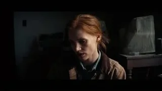 red-haired woman deep in thought in dim room — Interstellar