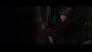 Young boy looking at Iron Man robot in dark room — Iron Man 3