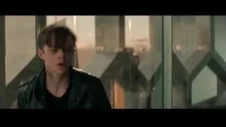 Young man by glass wall with city view — The Amazing Spider Man 2