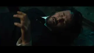 Man sitting on bench holding gun — John Wick: Chapter 4