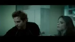 man and woman conversing in dimly lit room — Limitless