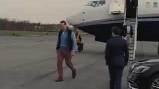 Men walking towards private jet on tarmac — Succession