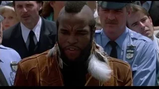 man with mohawk and feather jacket with police — Rocky III