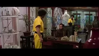 man in yellow robe with birdcage — Bruce Lee: Enter The Dragon