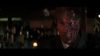 man's eerie menacing face in dimly lit bar — Batman: The Dark Knight