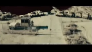 man in red cape in desert with military vehicles — Superman: Man of Steel