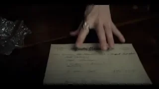 Hand resting on paper on wooden table — Peaky Blinders