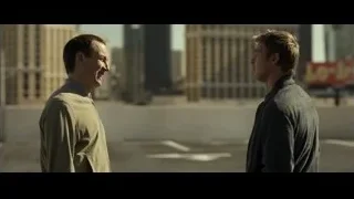 two men talking on city rooftop — F1