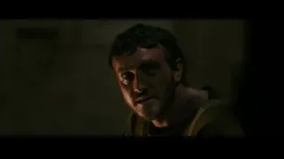 Man's face covered in blood and grime — Gladiator 2