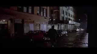 Black sports car on wet city street — American Psycho