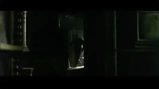 Black telephone on desk in dimly lit room — The Matrix