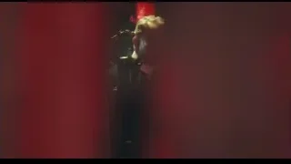 man in dimly lit room with red curtains — Peaky Blinders