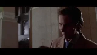 man in suit holding cat in hallway — American Psycho