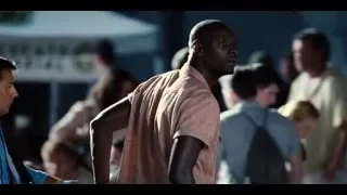 man in pink shirt dancing with arms raised — Jurassic World
