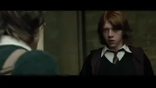 Ron Weasley in maroon vest by stone wall — Harry Potter and the Goblet of Fire