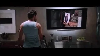 Man standing in kitchen looking at TV — Iron Man