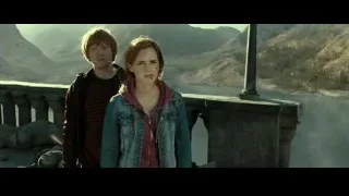 Young couple on balcony overlooking mountains — Harry Potter and the Deathly Hallows 2