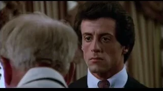 man in dark suit and red tie — Rocky III