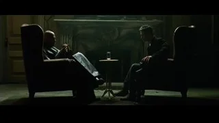 two men conversing by fireplace — The Matrix