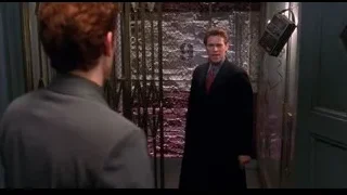 Man in suit standing by metal gate — Spider Man