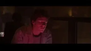 young man sitting in dimly lit room — The Social Network
