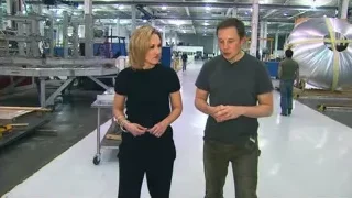 Man and woman conversing in industrial factory — Elon Musk: Return to Space