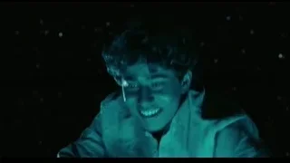 young man smiling in dark room with blue light — Life of Pi