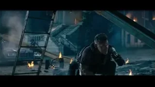 man kneeling in front of fire and rubble — Deadpool 2
