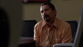 Man in orange shirt sitting at computer — Breaking Bad