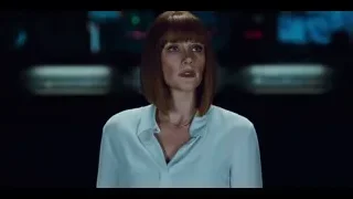 Woman with red hair in dimly lit room — Jurassic World