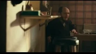 Man in black jacket at desk — Joker