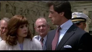 man in suit and woman in fur coat — Rocky III