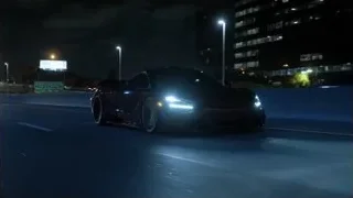 black sports car driving on highway at night — Sports Cars
