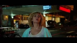 young woman on city street at night — Lucy