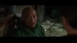 bald man in green jacket deep in thought — Batman