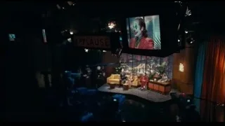 Stage with large screen displaying Joker — Joker