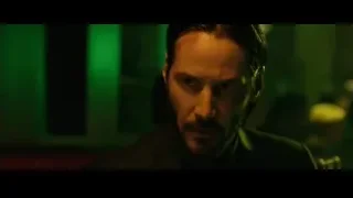 man sitting on couch with martini glass — John Wick