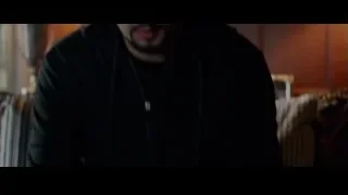 Man in hoodie deep in thought in dim room — Creed