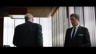 two men in suits in room with windows — Ford v Ferrari