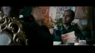 man in uniform at table in dimly lit room — The Dictator